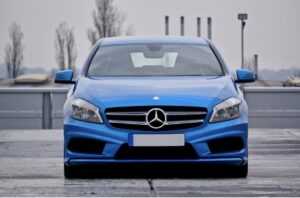 Blue car driving on a road